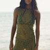 Model wearing the "Lace Musgo Stretch" green skirt from the summer 23/24 Matte collection in a beach in Costa Rica