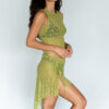 Model showing the lateral side of the "Lace Musgo Stretch" green skirt from the summer 23/24 Matte collection.