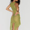 Model showing the back side of the "Lace Musgo Stretch" green skirt from the summer 23/24 Matte collection.