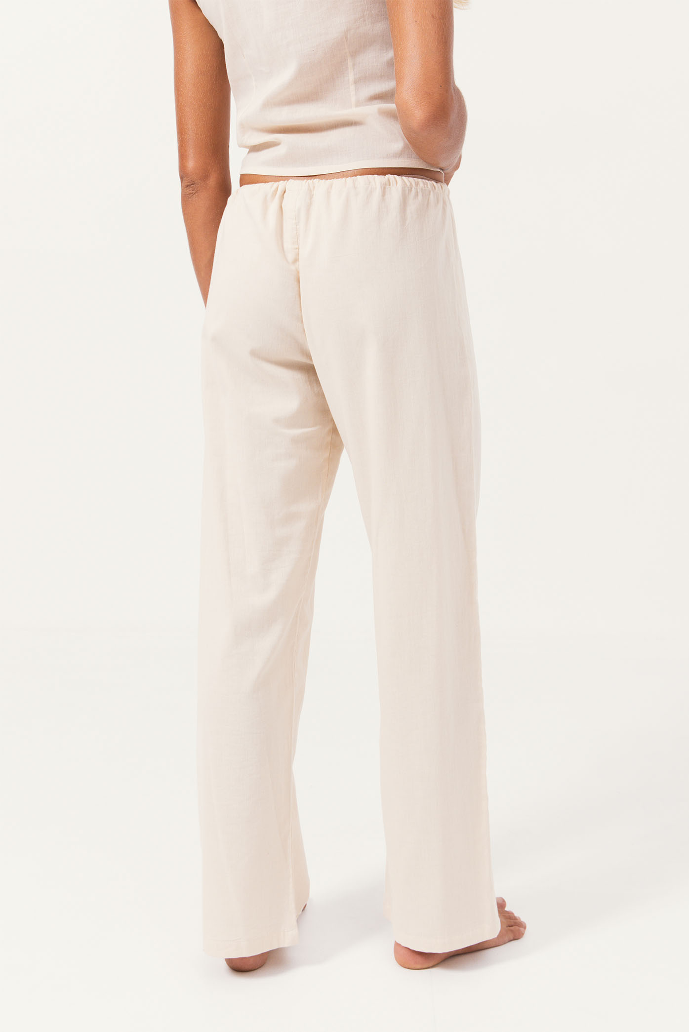 Model showing the back side of the "Paloma Pants" from the summer 24 Matte collection.