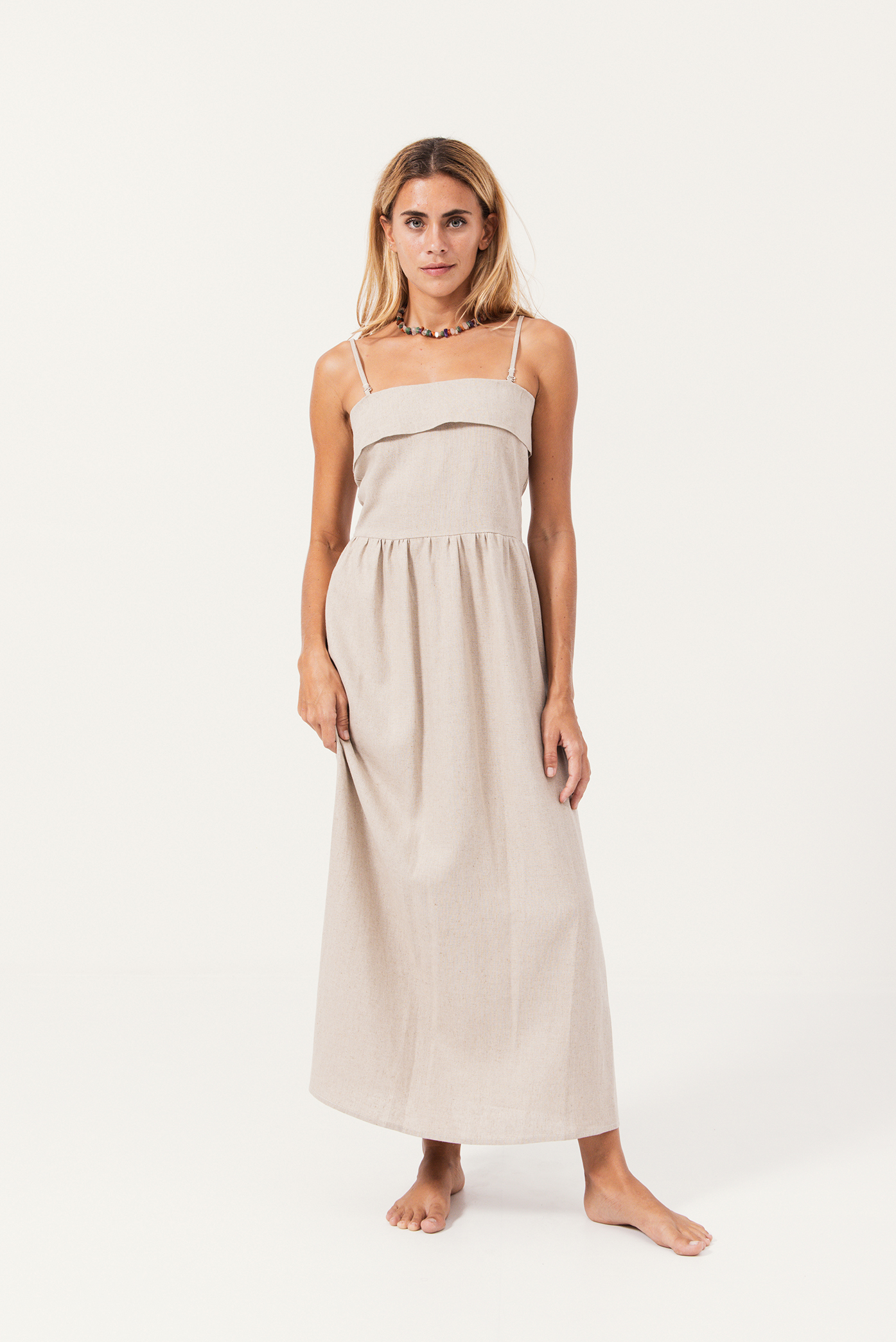 Model wearing the Arena Linen Midi Dress for our Summer 24/25 collection